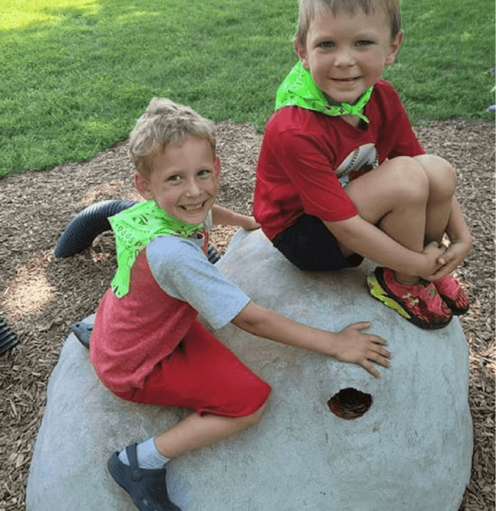 Children enjoying outdoor play at Mini Adventures Preschool in Warrensburg, MO, wearing colorful outfits.
