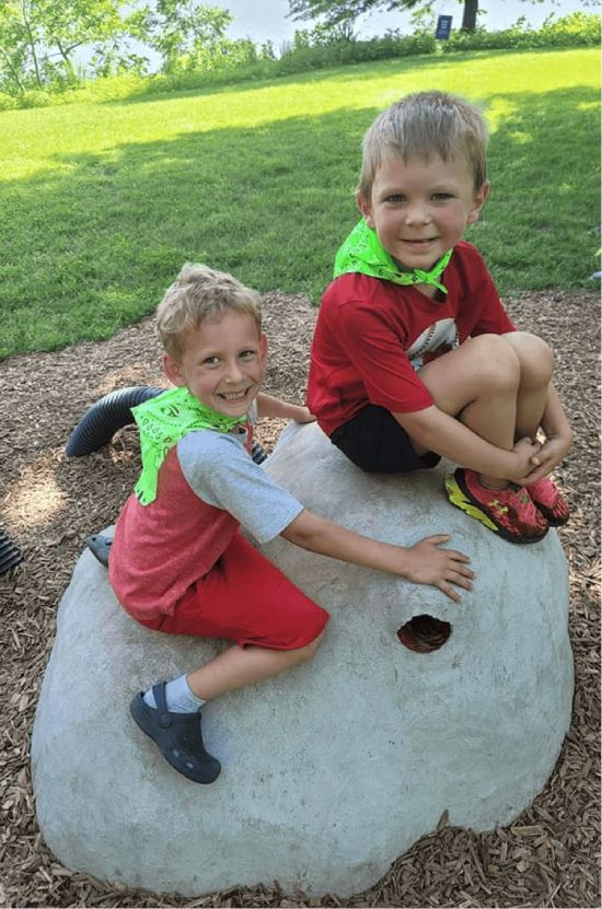 Children enjoying outdoor play at Mini Adventures Preschool in Warrensburg, MO, wearing colorful outfits.