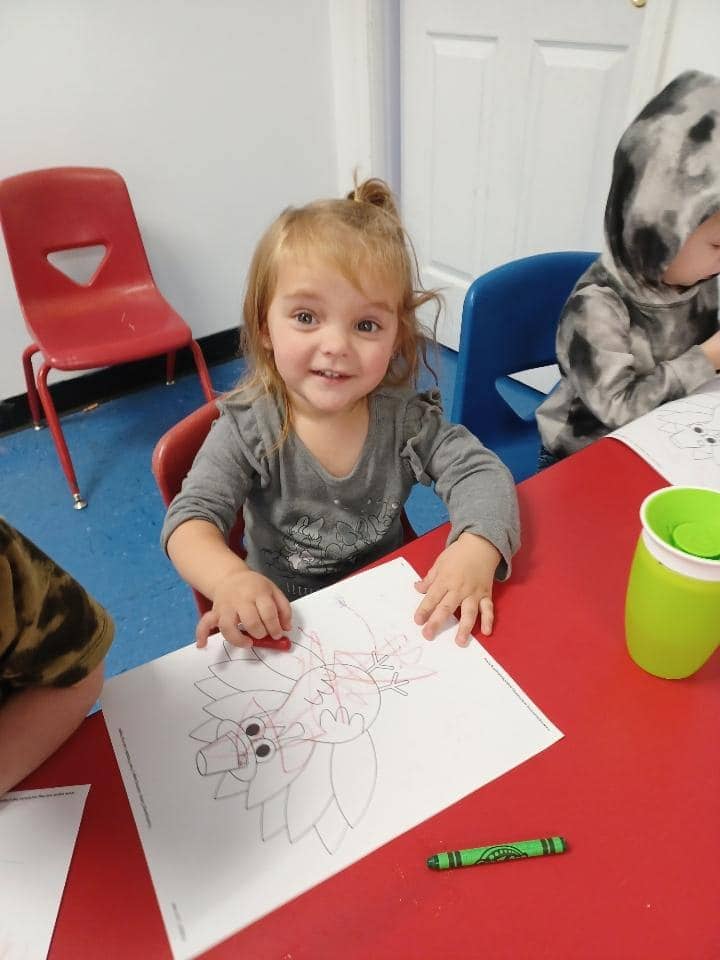 Child coloring a worksheet at Mini Adventures Preschool & Daycare in Warrensburg, MO.