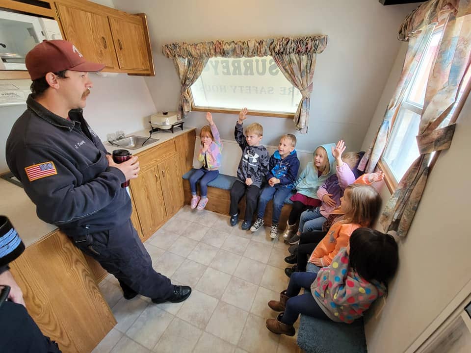 Kids learning with a counselor at Warrensburg, MO summer camp.