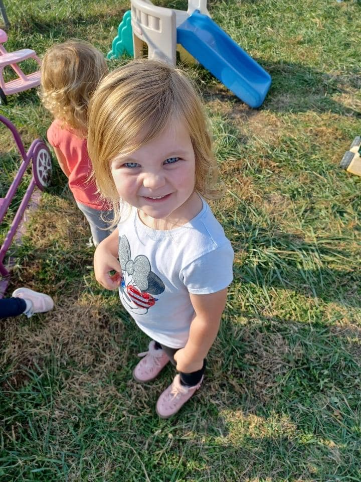 Child playing outdoors at Warrensburg before and after school care program.